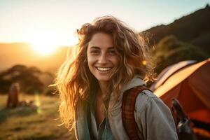 Portrait of girl looking at camera while near camping tent at sunset AI generated photo