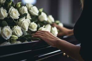 Closeup of a woman's hand placing a bouquet of white roses in a coffin.Funeral Concept AI generated photo