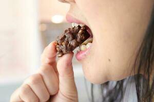 Close-up of a woman's mouth eating food photo