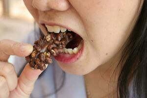 Close-up view of mouth eating food photo