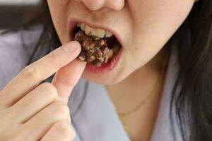 Close-up of a woman's mouth eating food photo