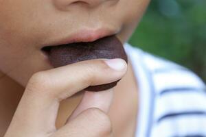 Close-up view of mouth eating food photo