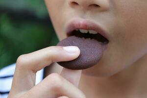 Close-up view of mouth eating food photo