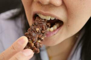 Close-up view of mouth eating food photo