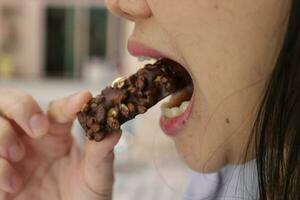 Close-up view of mouth eating food photo