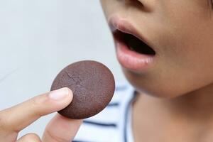 Close-up view of mouth eating food photo