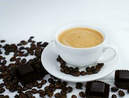 A cup of aromatic coffee and scattered coffee beans on the table. Close-up. Selective focus. photo