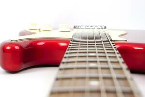 Selective focus, electric guitar neck on white background with copy space. Love, entertainment and music concept. photo