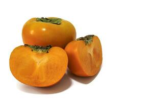Persimmons isolated on white background. Persimmons, with their mild sweetness and distinctive soft texture, are a fall fruit that adds a touch of seasonal deliciousness to any dish or dessert. photo