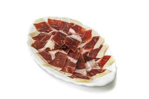 Iberico ham, isolated on white background. Spanish delicatessen concept. photo