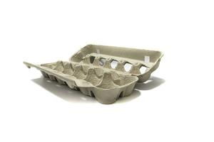 An egg carton container, for a dozen eggs. Isolated on a white background. Eco products concept. photo
