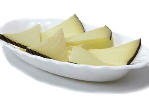 Pieces of cheeses served on a plate, isolated on white background. Concept of the best cheeses. photo