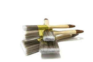 Lot of different sizes of paint brush , isolated on white background. Bristles can be made of various materials, such as natural hair, synthetic fibers, or a combination of both. photo