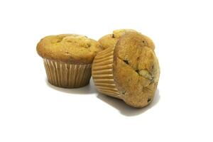 Muffins with chocolate flecks isolated on a white background. Muffins are made mainly from wheat flour, egg, vegetable oil, cow's milk, baking powder, essence ,vanilla being the most common, and sugar photo