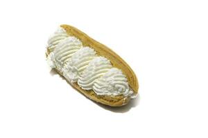 A French eclairs cake filled with cream, isolated on a white background.Traditional French eclairs are filled with vanilla cream and powdered sugar. photo