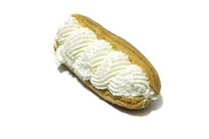 A French eclairs cake filled with cream, isolated on a white background.Traditional French eclairs are filled with vanilla cream and powdered sugar. photo