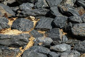 Pile of rocks background. Greyish and red colour. photo