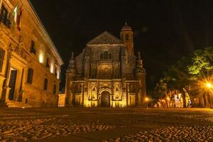 Ubeda, Jaen, Spain, 6.7.2023. Chapel of El Salvador ,El Salvador, and the Parador de Turismo de Ubeda, Jaen, Spain. Dean Ortega Palace. Night view. photo