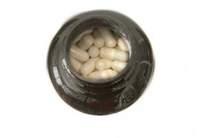 A bottle of magnesium citrate capsules. Isolated on white background. A dietary supplement that provides a highly absorbable form of magnesium and may be beneficial for bone and muscle health. photo