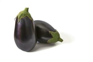 Eggplants isolated on white background. Eggplants are dark purple, oval-shaped vegetables with shiny skin and tender flesh, perfect for a variety of culinary dishes. photo