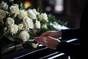 Closeup of a woman's hand placing a bouquet of white roses in a coffin.Funeral Concept AI generated photo