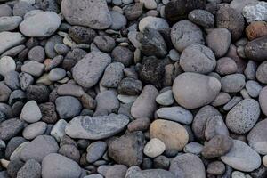 a pile of rocks and gravel on the beach photo