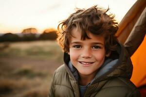 Portrait of a cute boy looking at camera while near his tent in nature AI generated photo