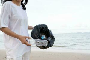 Save ocean. Volunteer pick up trash garbage at the beach and plastic bottles are difficult decompose prevent harm aquatic life. Earth, Environment, Greening planet, reduce global warming, Save world photo