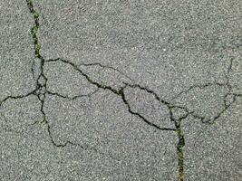 Asphalt surfaces of different streets and roads with cracks in close up photo