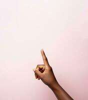 A womans hand pointing to the top in front of a pastel colored background. AI generative photo