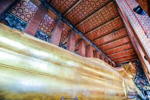 a golden reclining buddha photo