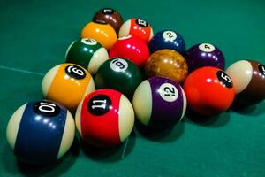 Pool cues close-up on a green table for playing photo