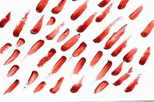 Smears of red cosmetic lipstick on a light background photo