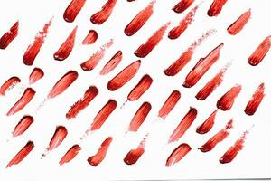 Smears of red cosmetic lipstick on a light background photo