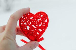 Decorative red heart for valentine's day in hands. photo