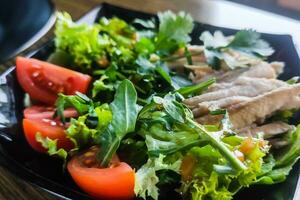 Arugula, meat, and tomato salad close-up photo