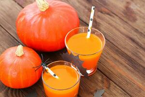 Pumpkin with juice on a wooden table, Halloween concept photo