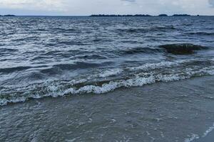 River bank with blue waves, water texture photo