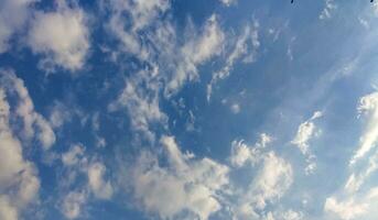 a blue sky with clouds and a few clouds, Blue sky, white cloud time lapse of clouds in the sky, the sun shines through the clouds in this photo, dramatic sky clouds photo