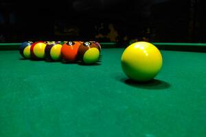 Pool cues close-up on a green table for playing photo