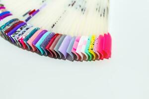 Palette of nail designs, testers of multicolored polishes on flat nails photo