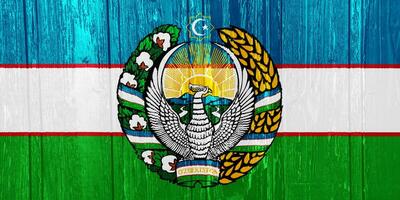 Flag and coat of arms of Republic of Uzbekistan on a textured background. Concept collage. photo