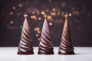 Artistic chocolate Christmas trees with glitter decorations isolated on a gradient background photo