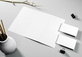 Blank trifold brochure and 2 business cards with concrete background, great for brochure mockups. photo