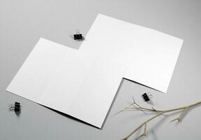 blank trifold brochures with paper texture and concrete background, great for mockups. photo