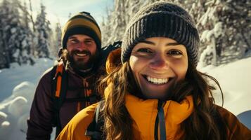 Cheerful couple snowshoeing in pine forest background with empty space for text photo