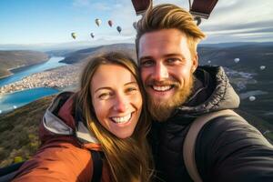 Overjoyed couple in hot air balloon overlooking sparkling snow clad valleys photo