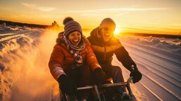 Cheerful couple tobogganing against stunning sunset on snowy slope photo