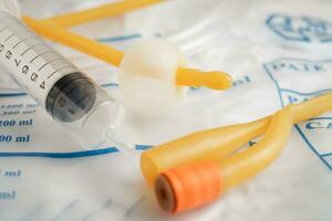 Foley catheter and urine drainage bag collect urine for disability or patient in hospital. photo