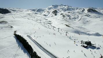 People skiing on the ski slope in winter, aerial view. Portalet Formigal, Spain photo